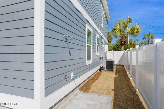 view of side of home with central AC