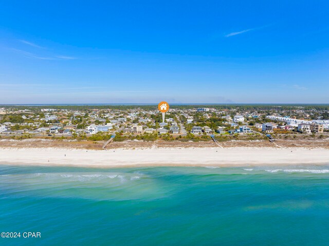 birds eye view of property featuring a beach view and a water view