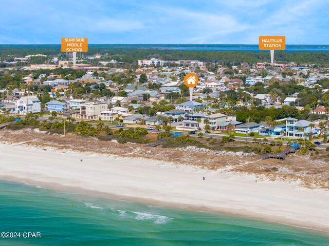 birds eye view of property with a water view and a view of the beach