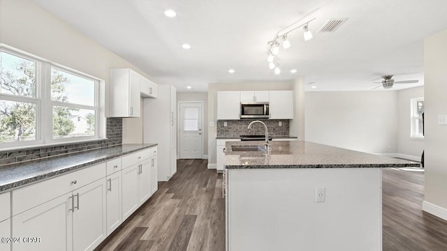 kitchen with white cabinetry, dark hardwood / wood-style floors, and sink