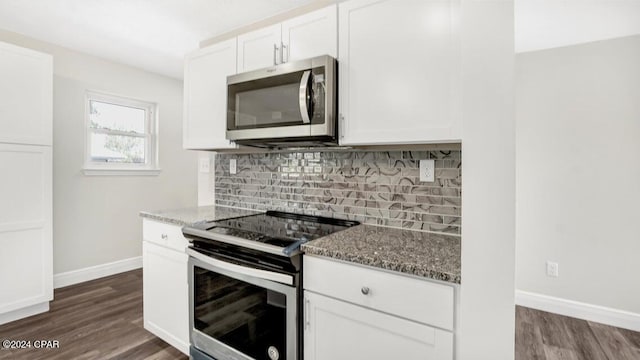 kitchen with stainless steel appliances, white cabinets, dark wood-type flooring, and stone counters