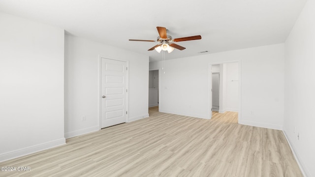 unfurnished bedroom featuring ceiling fan, visible vents, baseboards, and light wood-style flooring