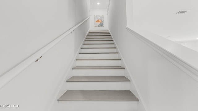 staircase featuring visible vents