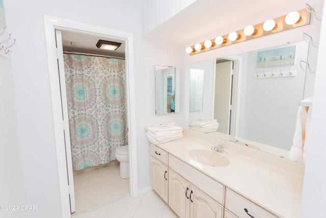 bathroom featuring vanity, toilet, and tile patterned floors