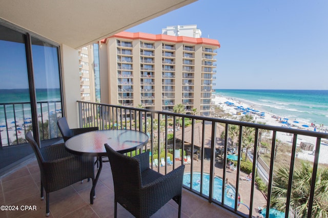 balcony featuring a water view and a view of the beach