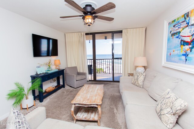 living room featuring carpet floors and ceiling fan