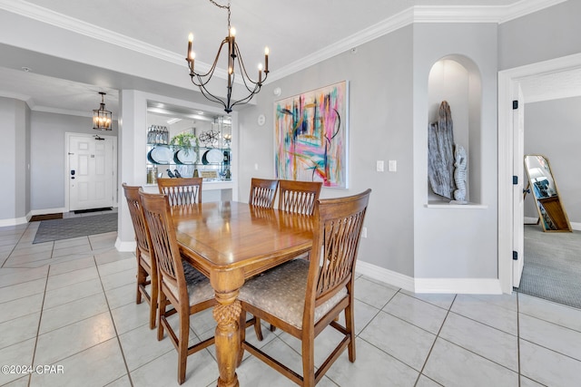 dining room with a notable chandelier, ornamental molding, and light tile floors