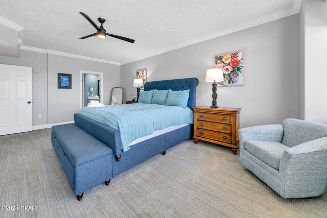 carpeted bedroom with ensuite bathroom, ceiling fan, a textured ceiling, and crown molding