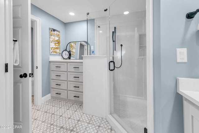 bathroom featuring tile floors, an enclosed shower, and vanity