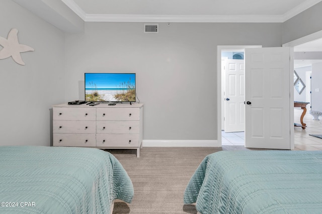 carpeted bedroom featuring crown molding