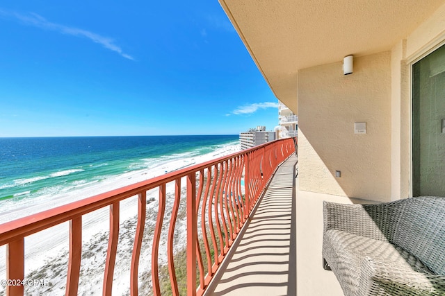 balcony with a beach view and a water view