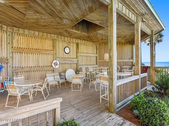 wooden terrace featuring a water view