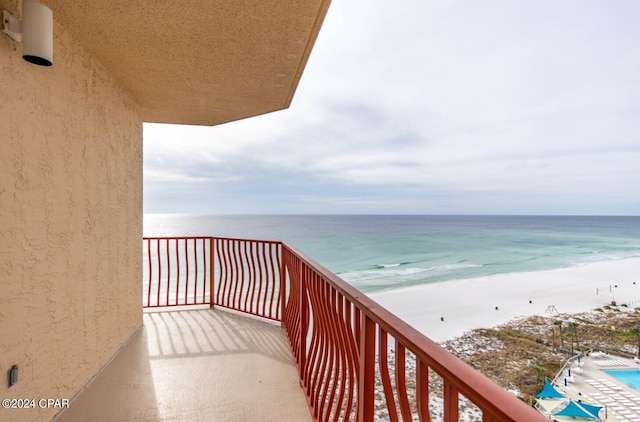 balcony with a view of the beach and a water view