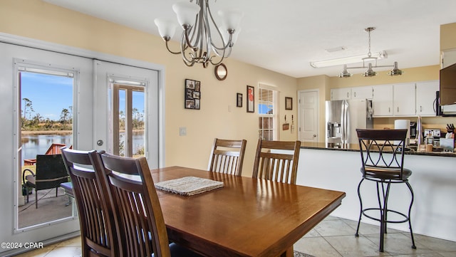 tiled dining area with rail lighting and a notable chandelier