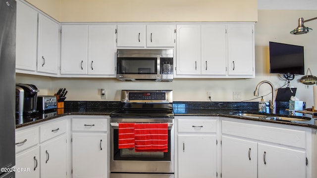 kitchen with white cabinets, stainless steel appliances, and sink