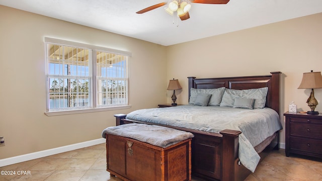 tiled bedroom featuring ceiling fan