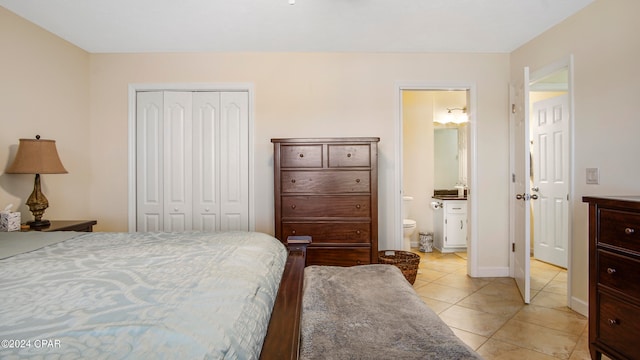 tiled bedroom with a closet and connected bathroom