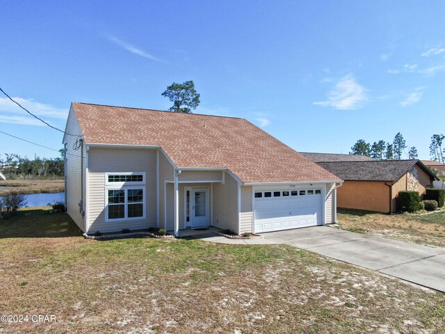 ranch-style home featuring a garage and a front lawn