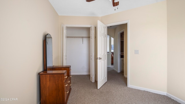 carpeted bedroom featuring ceiling fan and a closet