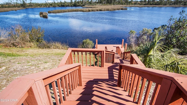 exterior space with a deck with water view