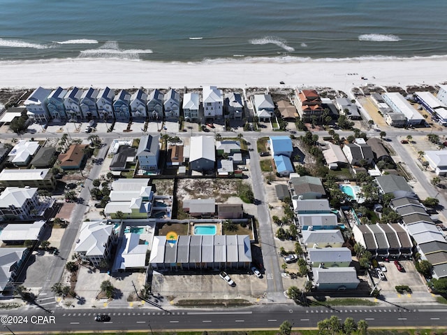 bird's eye view with a water view and a view of the beach