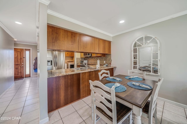 kitchen featuring appliances with stainless steel finishes, kitchen peninsula, light tile patterned floors, and tasteful backsplash