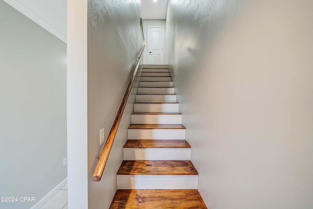 stairway with hardwood / wood-style flooring