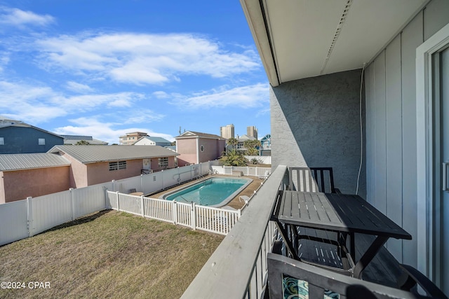 view of pool with a yard