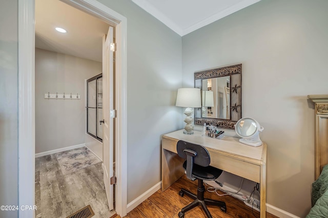 home office featuring ornamental molding and hardwood / wood-style flooring