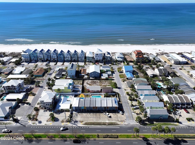 drone / aerial view featuring a water view and a view of the beach