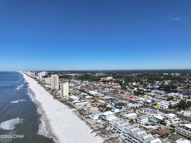 drone / aerial view with a water view and a beach view