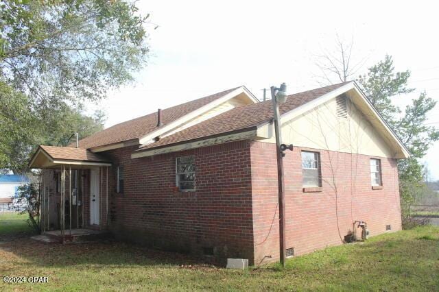 view of home's exterior with a yard