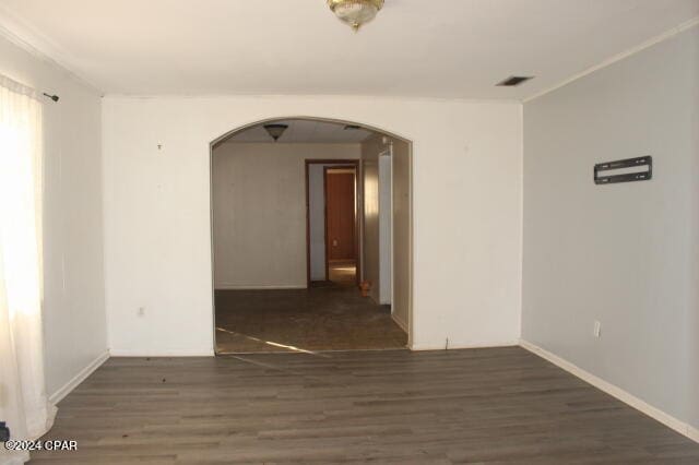 empty room with dark hardwood / wood-style flooring