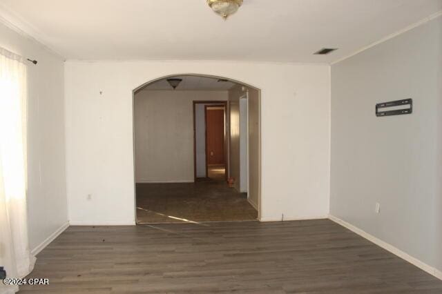 unfurnished room with dark hardwood / wood-style flooring