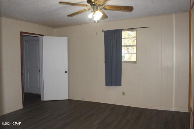 spare room featuring ceiling fan and dark hardwood / wood-style floors