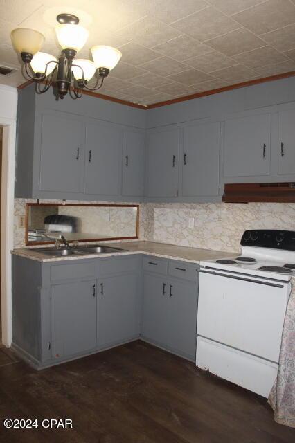 kitchen featuring custom range hood, dark hardwood / wood-style flooring, white range with electric stovetop, a notable chandelier, and tasteful backsplash