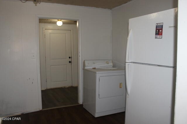 clothes washing area with dark hardwood / wood-style floors and washer / clothes dryer