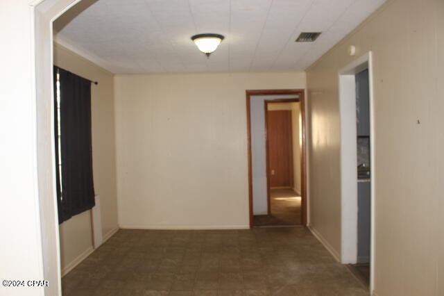 spare room with dark tile flooring