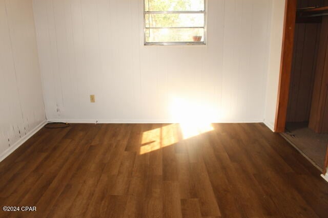 unfurnished room featuring dark hardwood / wood-style flooring