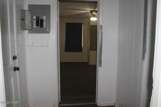 hall with dark wood-type flooring and electric panel