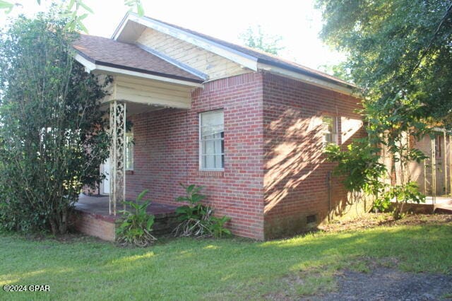 view of property exterior with a lawn