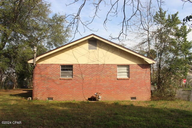 view of property exterior with a lawn