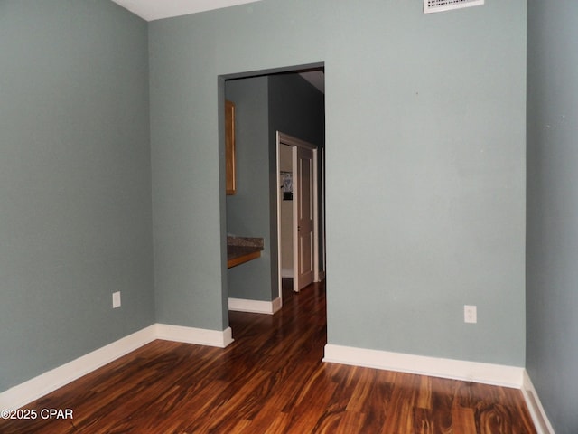 empty room featuring dark wood-type flooring