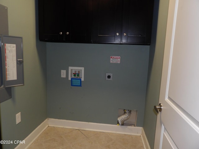 laundry area with electric dryer hookup, cabinets, electric panel, hookup for a washing machine, and light tile patterned flooring