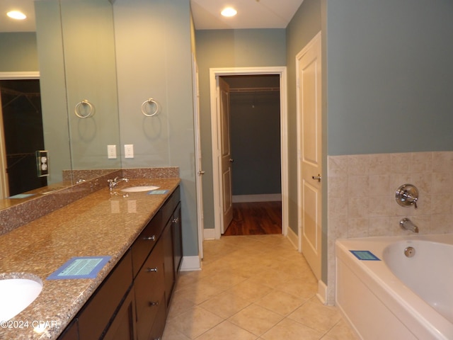 bathroom with vanity, a tub to relax in, and tile patterned floors