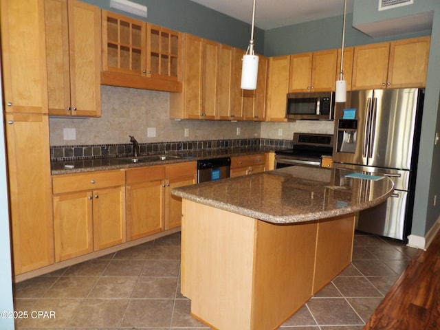 kitchen with dark tile patterned flooring, sink, decorative light fixtures, a kitchen island, and stainless steel appliances