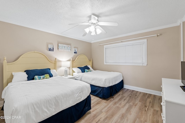 bedroom with a textured ceiling, ornamental molding, ceiling fan, and light wood-type flooring