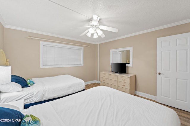 bedroom with ornamental molding, a textured ceiling, ceiling fan, and light hardwood / wood-style flooring