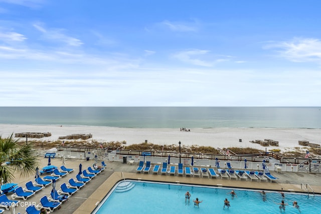 view of swimming pool with a water view and a patio area