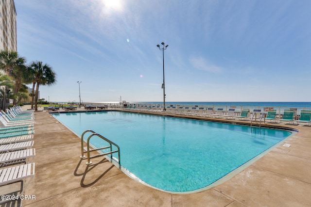 view of pool with a water view